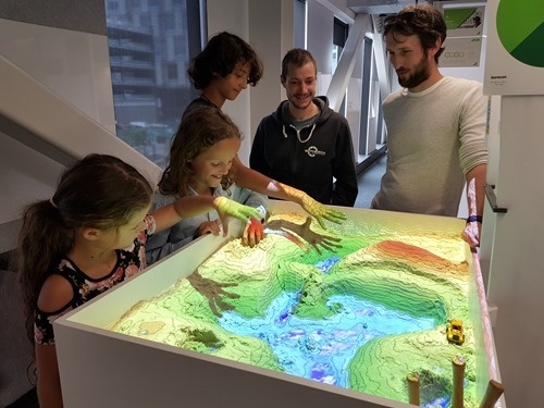 The kids playing with the AR Sandbox at Aurecon