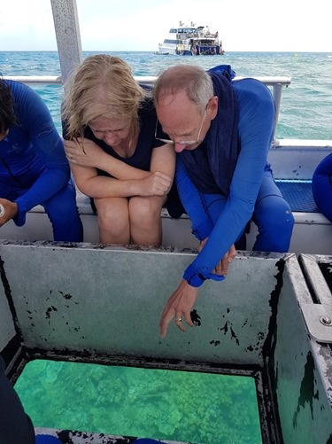 The glass-bottomed boat with the Reef Experience in the back ground