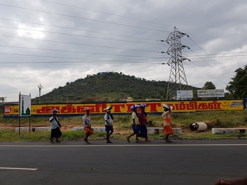 A friendly group of men, walking and carrying