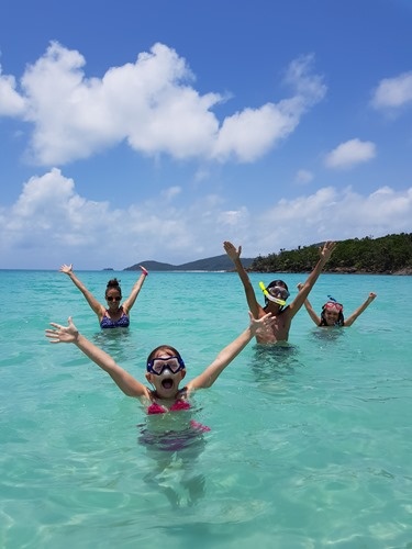 The family in the water at Whitehaven Beach