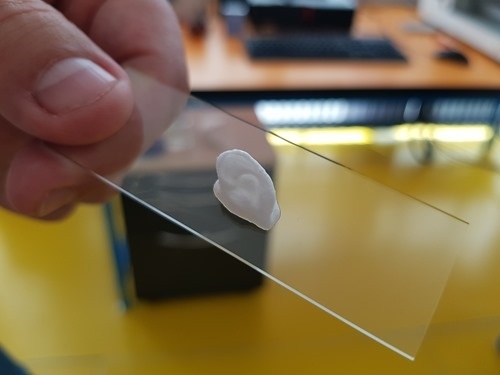 A tiny ear printed in Nivea cream