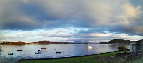Light hitting a siling boat in the little bay